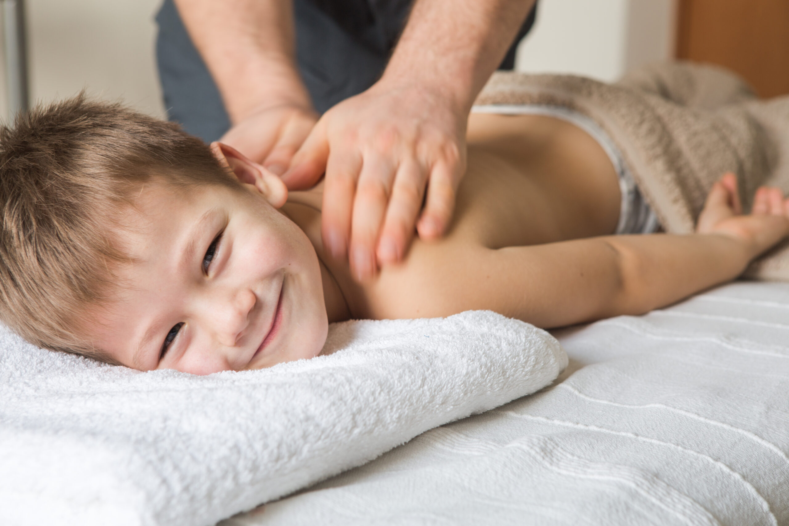 Boy,Toddler,Relaxes,From,A,Therapeutic,Massage.,Physiotherapist,Working,With